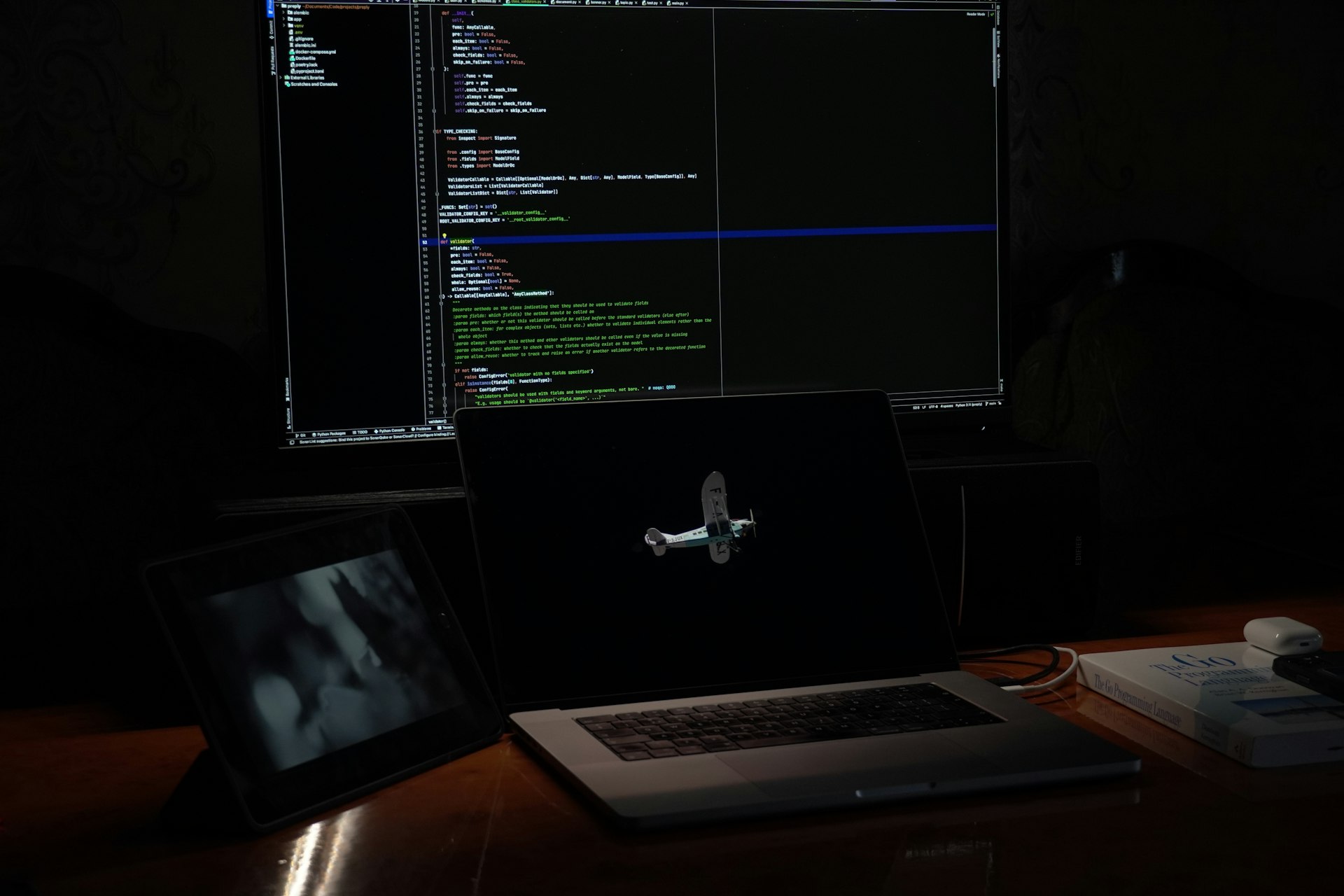 a laptop computer sitting on top of a wooden desk
